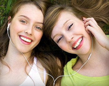 Smiling girls with good smiles in South San Jose sharing headphones