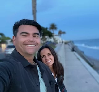Smiling husband and wife with porcelain dental veneers in San Jose