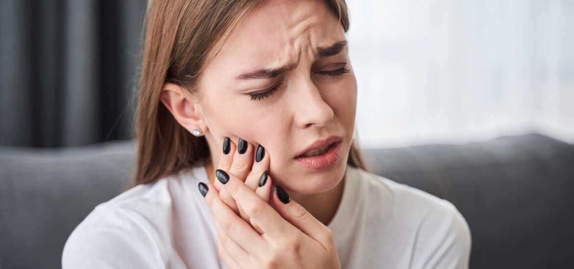 young woman suffering from TMJ related jaw pain in San Jose