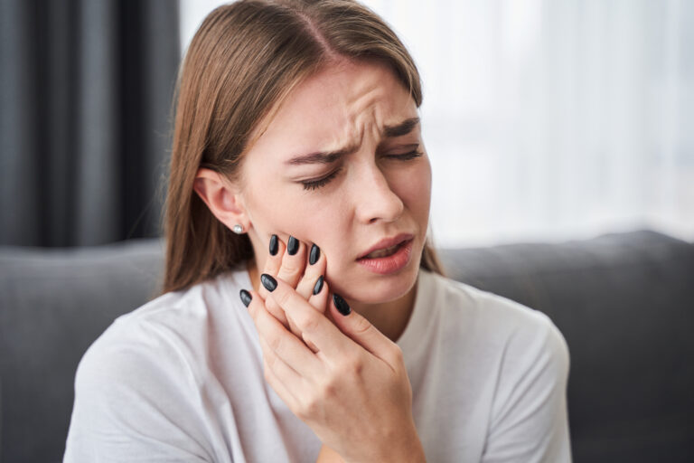 young woman suffering from TMJ related jaw pain in San Jose