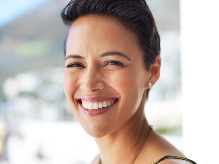 closeup of a smiling woman with perfect dental implants