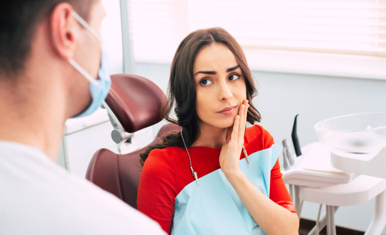 young woman with tooth pain, tooth extraction