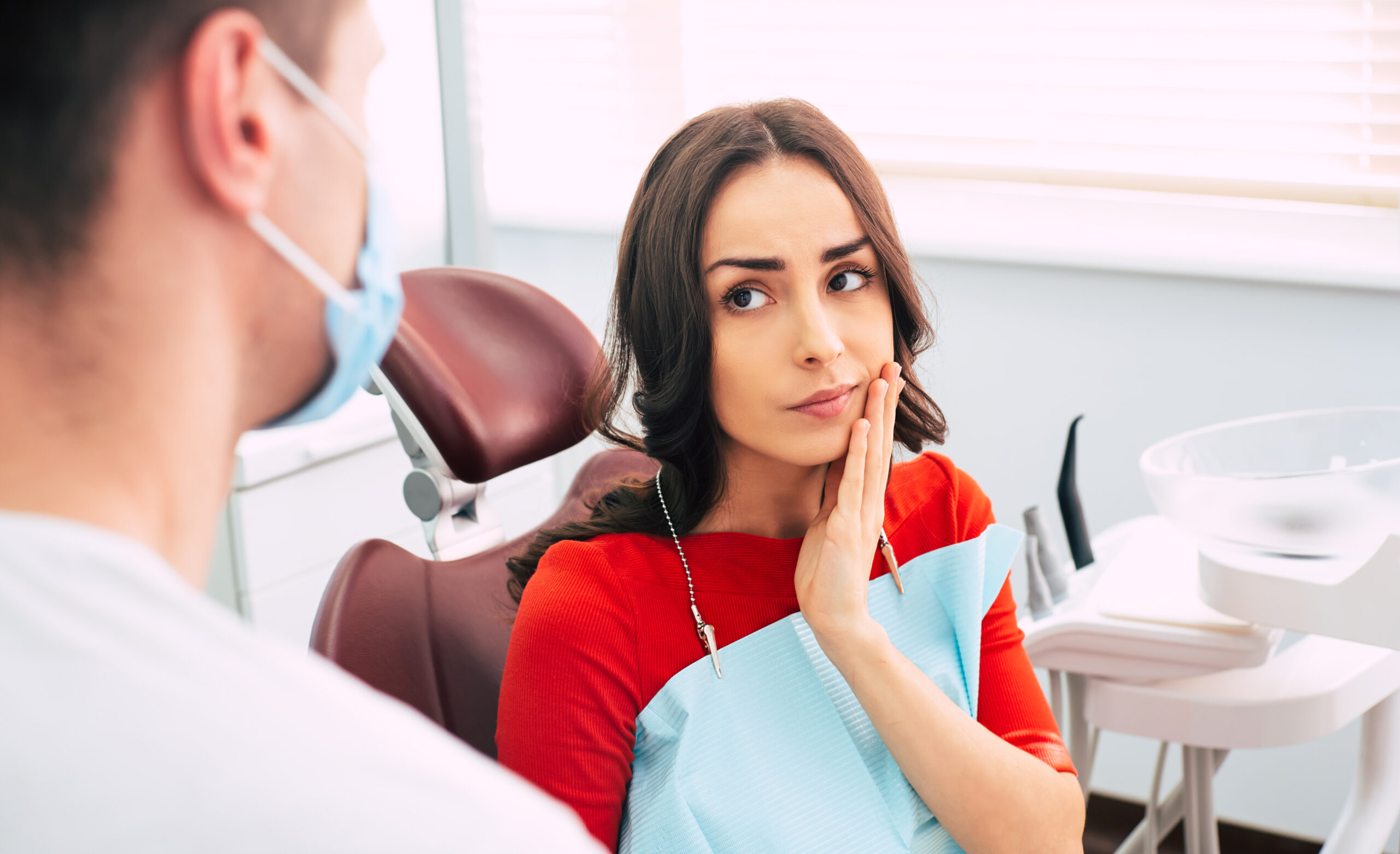 young woman with tooth pain, tooth extraction