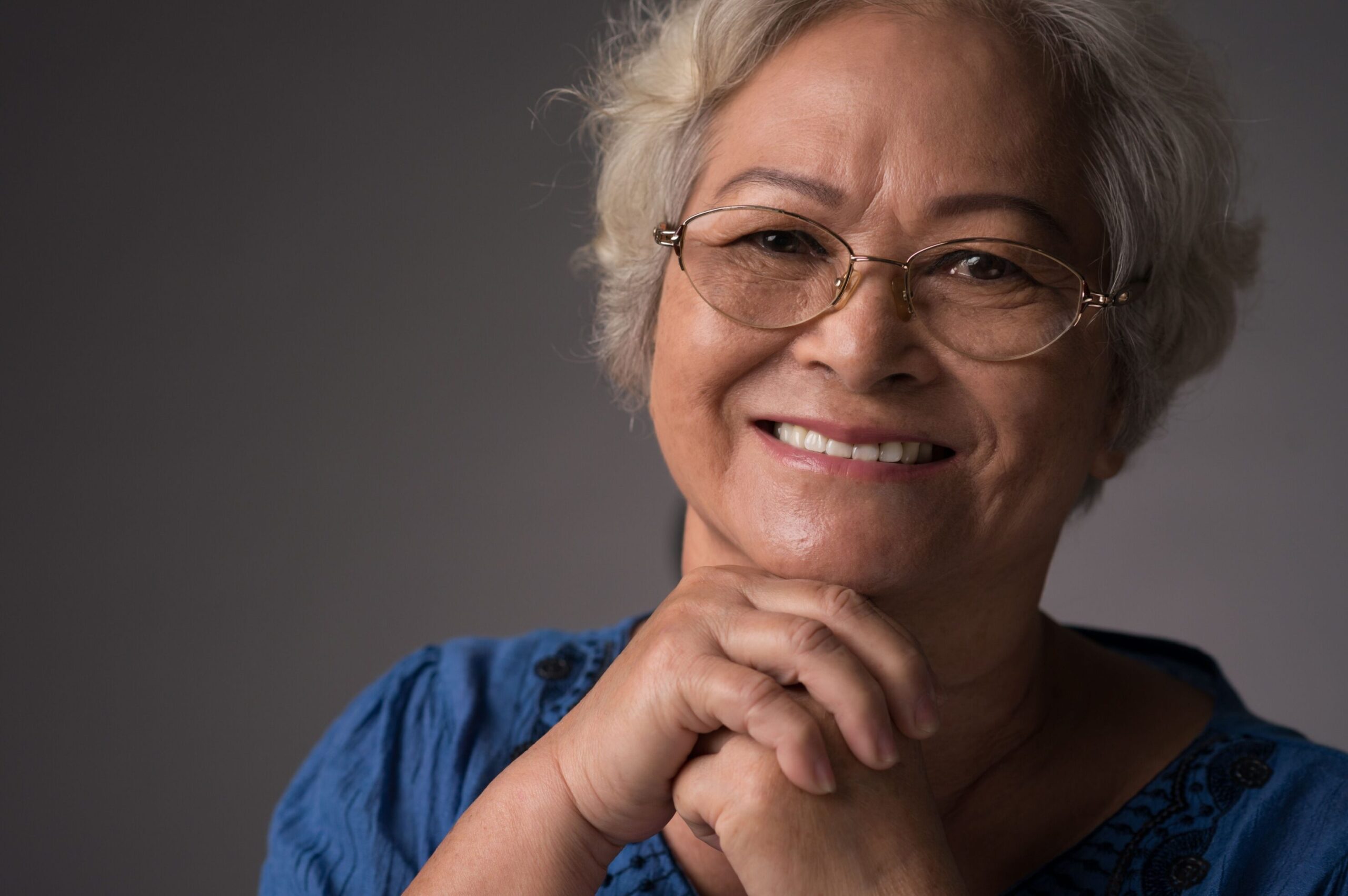 San Jose woman showing off her full mouth implant supported dentures