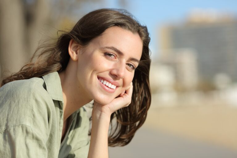 happy young woman smiling outdoors